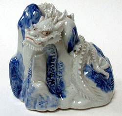 20. Chinese dragon on mound, porcelain, 18-19th century (5" x 5")